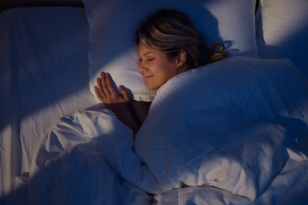 A woman sleeping peacefully in soft moonlight